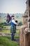 Bagpiper plays in churchyard overlooking landscape.