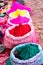 Bags of colored powdered paint sit waiting to be sold to Holi Fe