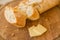 Baguete and slices of cheese on cutting board