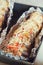 Baguette baked with meat, cheese and tomato