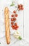 Baguette with banch of cherry-tomatoes, basil and