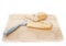 Baguette and bread knife on chopping board