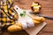 Baguette, butter, knife and parsley on a cutting board