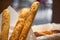 Baguette close up with pastry buffet on background