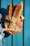 Baguettes. Paper bag with baguette in hands of woman