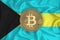 Bahamas flag, bitcoin gold coin on flag background. The concept of blockchain, bitcoin, currency decentralization in the country.