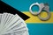 Bahamas flag with handcuffs and a bundle of dollars. The concept of illegal banking operations in US currency