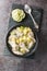 Bahamian Chicken Souse with chicken wings, potatoes, celery, lime and spices closeup on the plate. Vertical top view