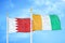 Bahrain and Cote d`Ivoire Ivory coast two flags on flagpoles and blue sky