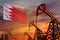 Bahrain oil industry concept. Industrial illustration - Bahrain flag and oil wells with the red and blue sunset or sunrise sky