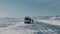 BAIKAL, IRKUTSK REGION, RUSSIA - MARCH 18, 2021: Men and women board a microbus during a winter journey across the ice