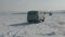 Baikal, Irkutsk Region, Russia - March 18, 2021: Two UAZ minibuses ride on snow-covered bumps on the ice of Lake Baikal