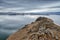 Baikal Lake and Kobilya golova rock in the December cold. Time of freeze-up. Ice floes is swiming on the water