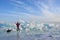 Baikal lake, Russia, March, 01, 2017. Traveler with a sledge-drag going in front of the ice ridges near the village of Bolshie Kot