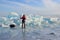 Baikal lake, Russia, March, 01, 2017. Traveler with a sledge-drag harrows in front of the ice ridges near the village of Bolshie K