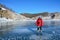 Baikal lake, Russia, March, 13, 2017.Russia, Olkhon island. Tourist skating on Baikal ice in march