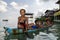 Bajau children relax on a dug out boat near shoreline in Sabah, Malaysia.