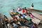 Bajau waiting for tourists to distribute food to them on the boat