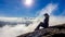 Bajawa - A Girl sitting on the side of a volcano, surrounded by clouds