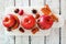 Baked apples with caramel, brown sugar and and nuts, top view on white wood