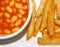 Baked beans and Golden Chips / French Fries on a white plate