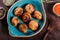 Baked champignons mushrooms with butter, spices on wooden background.