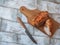 Baked chicken breast with spices  whole piece and cut on a wooden board and a kitchen knife