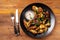 Baked chicken wings in Mexican with curry seasoning and parsley on a black plate, on a wooden background. side view, copy space