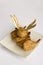 Baked Coconut Shrimp on a square plate with two vintage gold Forks