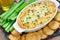 Baked crab dip, served with celery sticks, crackers