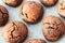 Baked cracked round chocolate cookies on a baking sheet with parchment paper just taken out of the oven. Tea or coffee snack