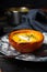 Baked creamy pumpkin soup served in a halved small pumpkin on a vintage plate