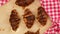 Baked crispy croissants on brown parchment paper sheet, food rotates