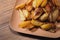 Baked crispy potatoes in a brown plate