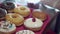 The baked donuts are being glazed and decorated with topping