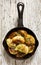 Baked dumplings on a cast-iron frying pan