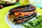 Baked eggplant slices stuffed with vegetables. Satisfying vegan dish.