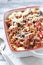 Baked fusilli pasta with cherry tomatoes, olives and mozzarella cheese.