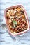 Baked fusilli pasta with cherry tomatoes, olives and mozzarella cheese.