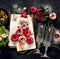 Baked ham with vegetablesand donuts on dark background. Christmas food