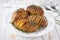 baked Hasselback potato in a plate, close up