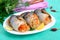 Baked herring stuffed with vegetables. Tasty fish rolls