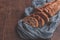 Baked homemade bread on a wooden table with a gray gauze tablecloth