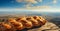 baked homemade challah, festive bread on table against backdrop of landscape. Close-up. AI generated