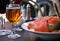 Baked jacket potato with salmon and glass of cider