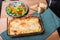 Baked lasagne dish with salad