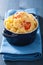 Baked macaroni with cheese in blue casserole