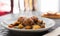 baked meatballs with stewed eggplant, zucchini, green peppers and tomatoes with haze in bowl