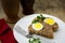 Baked meatloaf with boiled eggs for Easter on rustic wood