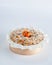 Baked mini crumble cake with dried fruits and chocolate chips on recycle Mini Wooden Baking Mold, white background, copy space,